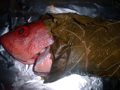 snapper wrapped in vine leaves, uncooked