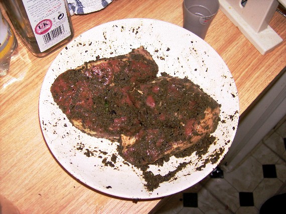 lamb leg steaks marinating in olive and basil paste